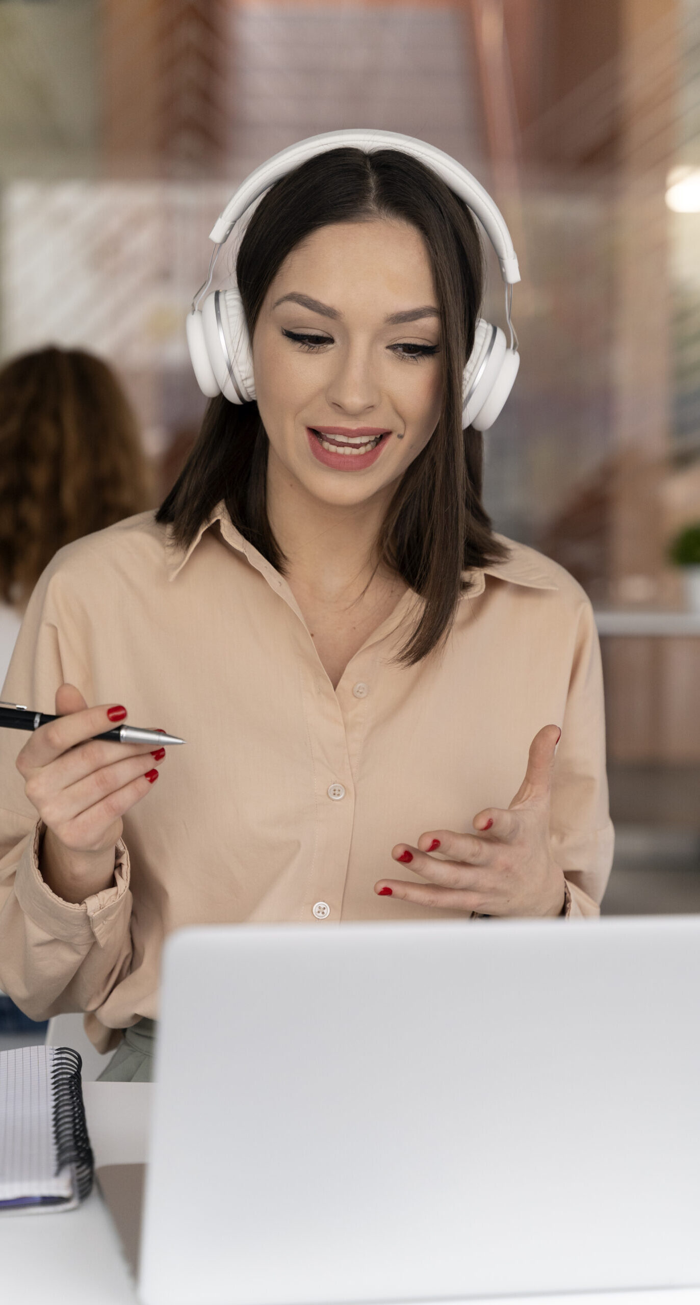 young-business-woman-working-office-with-laptop-headphones-scaled-e1718119733472.jpg